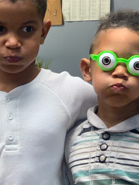 Two kids making funny faces together.