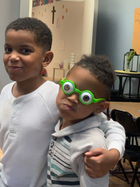 Two children posing with playful expressions.