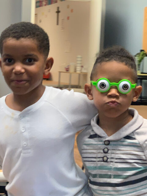 Two boys, one wearing funny glasses.