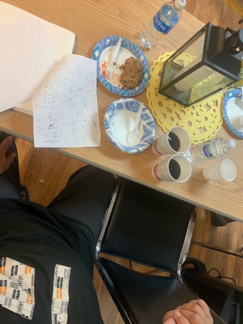 Table with snacks, papers, and lantern.