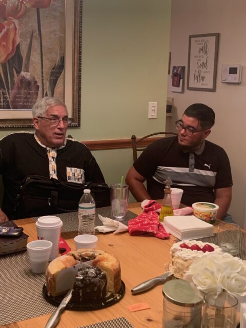 Two people sitting at a dining table.