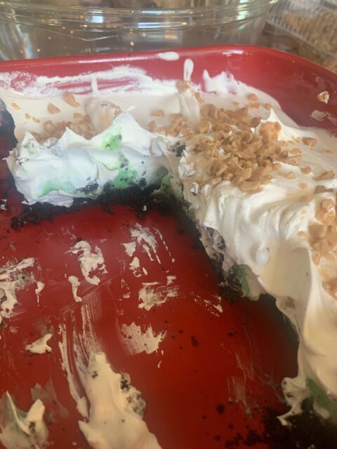Dessert with whipped topping and nut pieces.