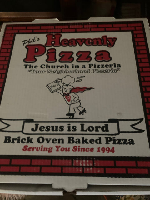 Pizza box with religious-themed design.