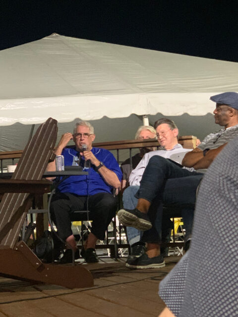 Panel discussion under a large outdoor tent.