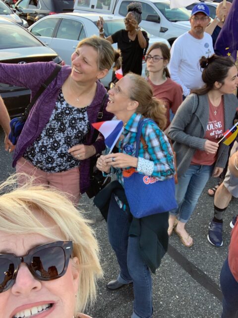 Group of people gathered outdoors, smiling.