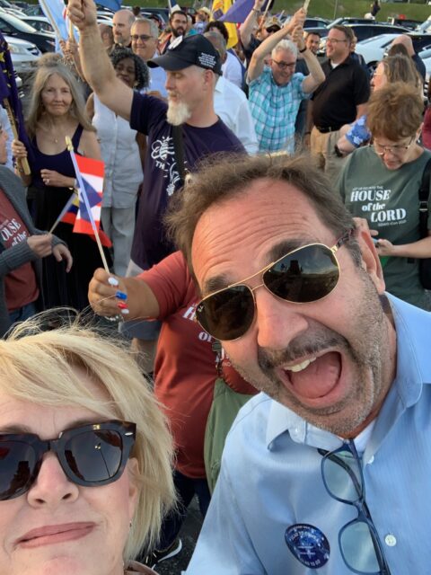 Group of people smiling at a gathering.