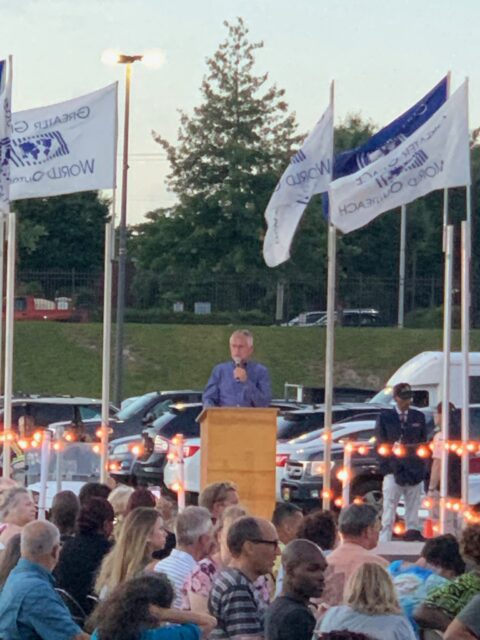 Outdoor event with speaker at podium.