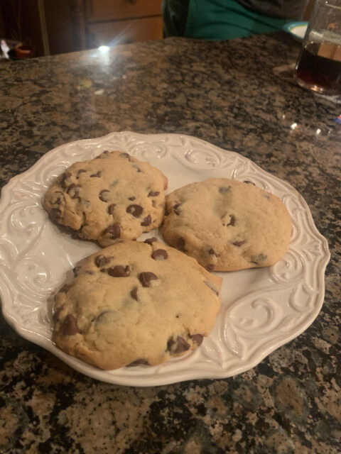 Plate of chocolate chip cookies on counter.