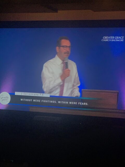Man speaking at a church podium.