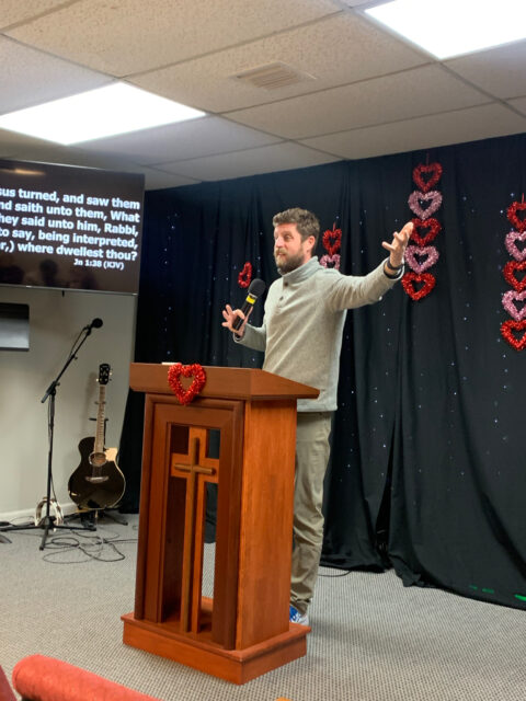 Man speaking at a church podium.