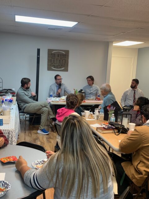 Group discussion around a table in meeting.