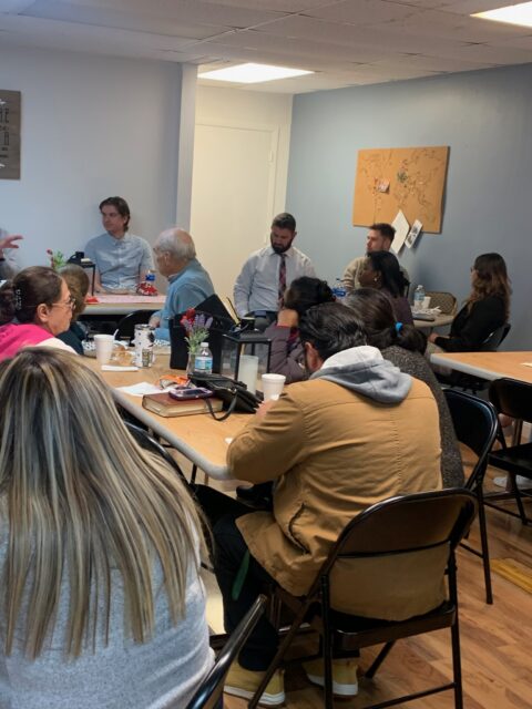People sitting in a meeting room discussion.