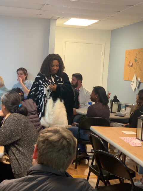 People gathered in a room, talking together.