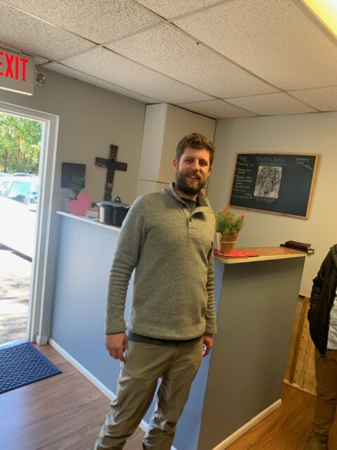Man standing in a room by counter.
