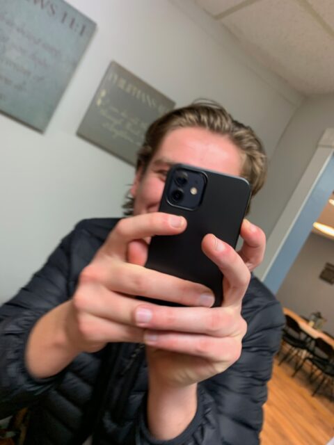 Person holding a smartphone, taking a picture.