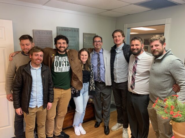 Group of people smiling in an office.