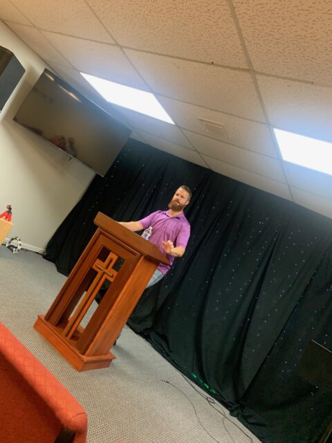 Person speaking at a podium with microphone.