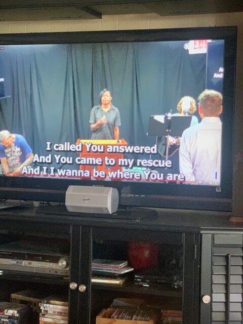 TV screen displaying a karaoke performance scene.