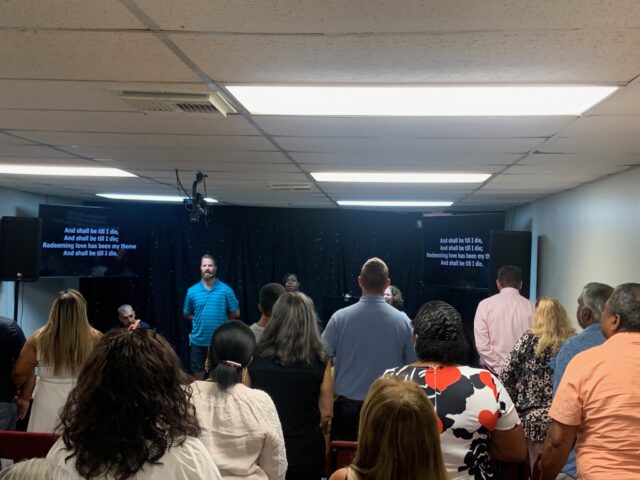 People attending a church service indoors.