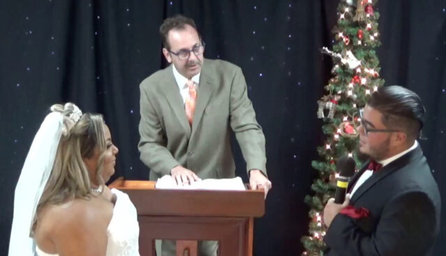 Wedding ceremony with officiant and couple.
