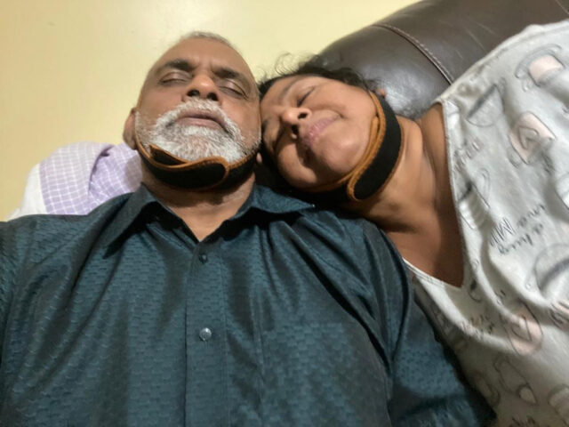 Couple resting with neck pillows.